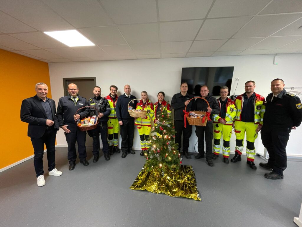 Bürgermeister Dirk Tolkemitt (links) dankt den an Heiligabend diensthabenden Einsatzkräften aus Polizei, Rettungsdienst und Feuerwehr.